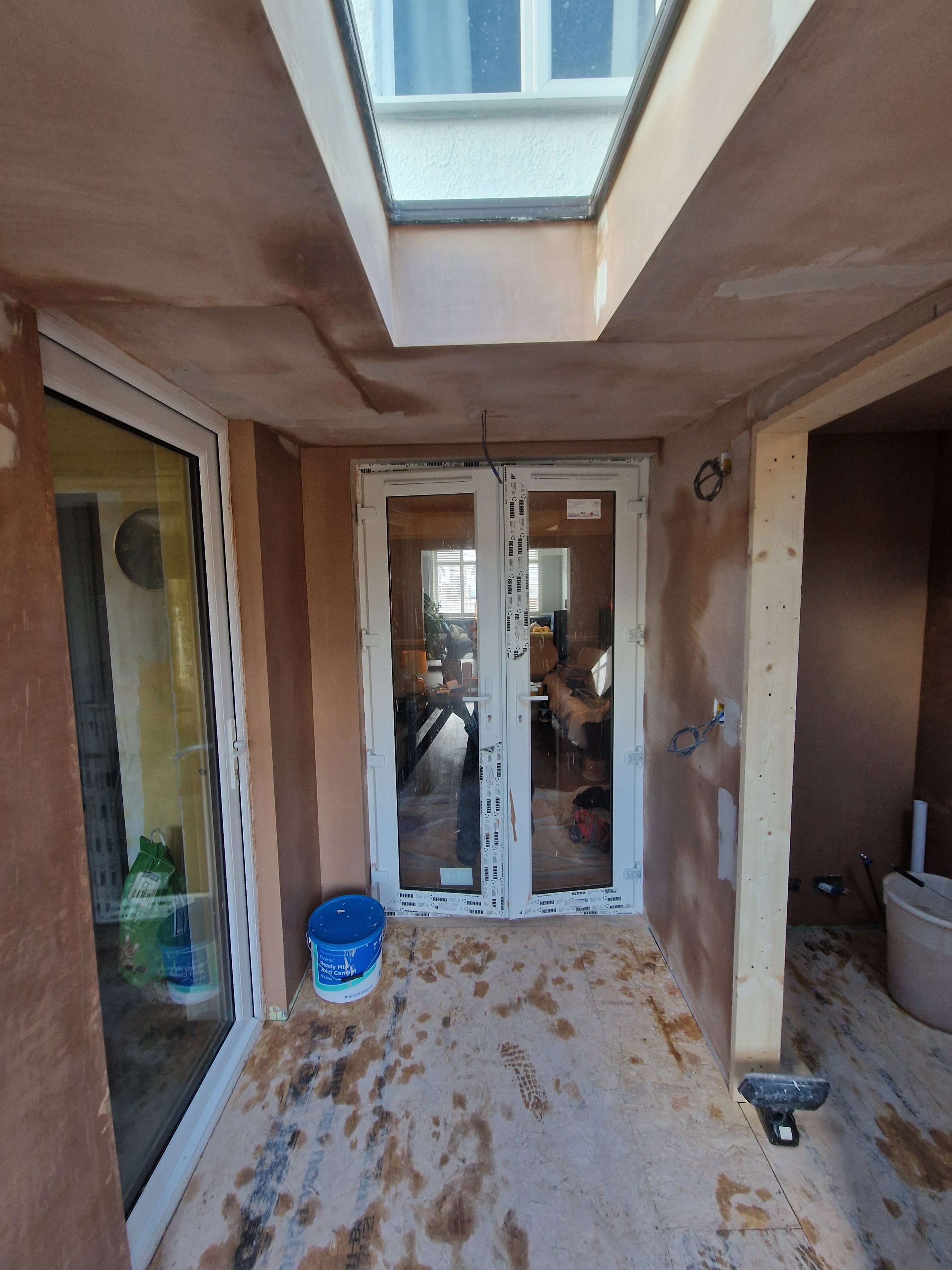 Extension under construction, with a rooflight and glazed doors installed to bring natural light into the new space.